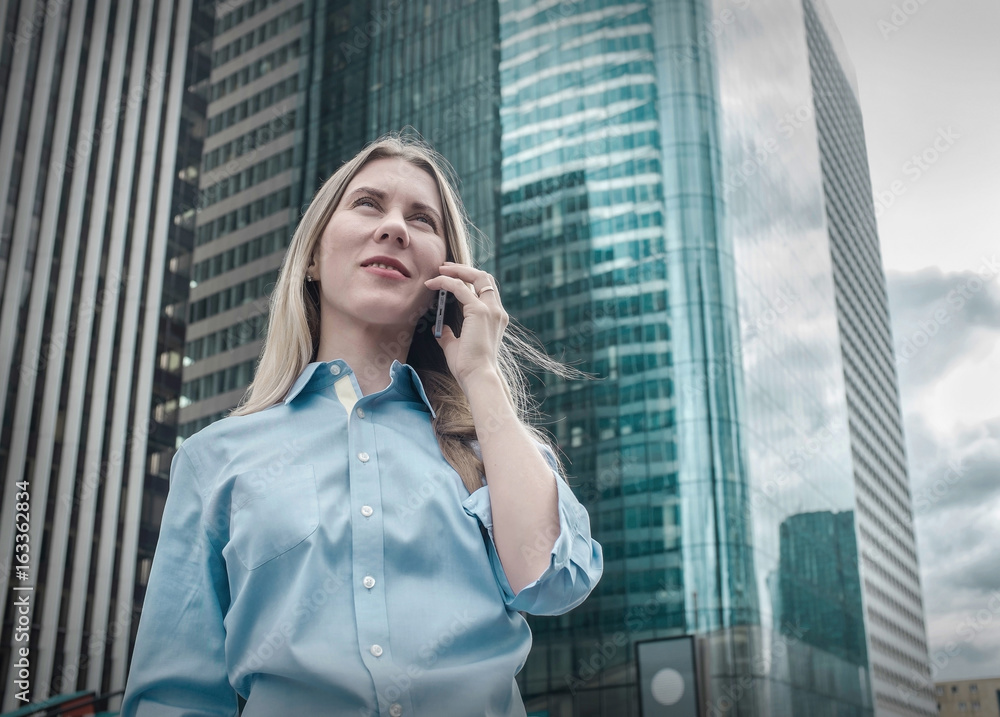 Businesswoman. Happiness businessman with phone around skyscrape Businesswoman. Happiness businessman with phone around skyscrape