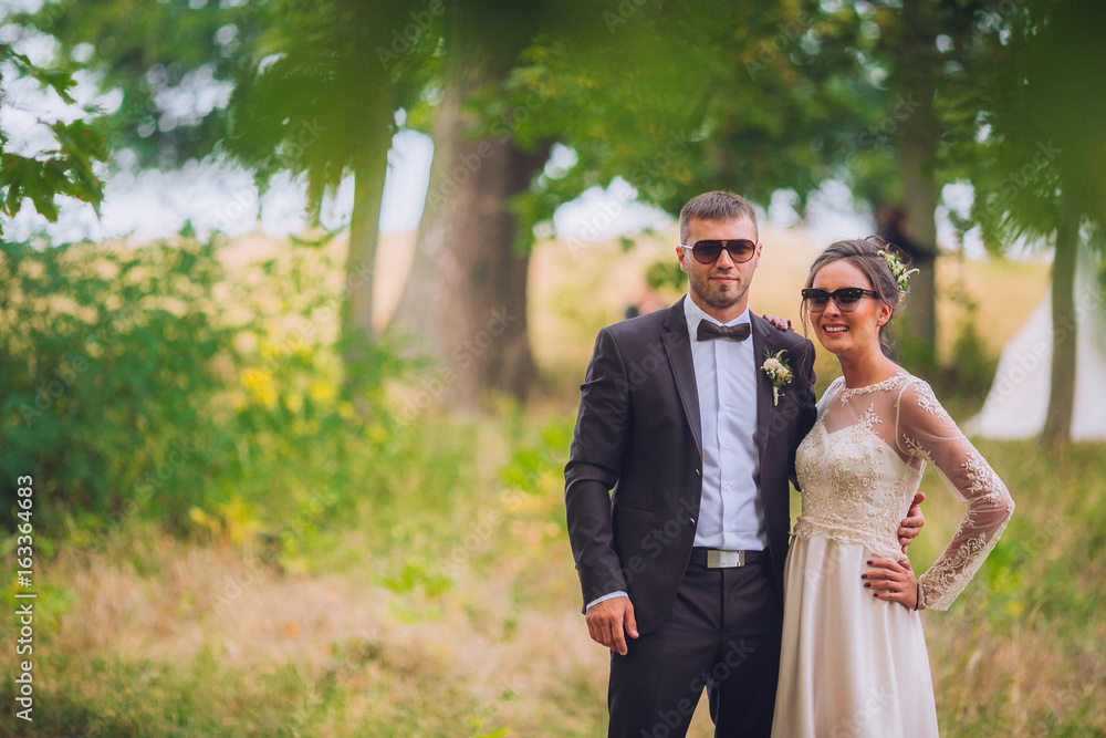 groomsman and bridesmaid in the park embracing. groomsman and bridesmaid in the park embracing.
