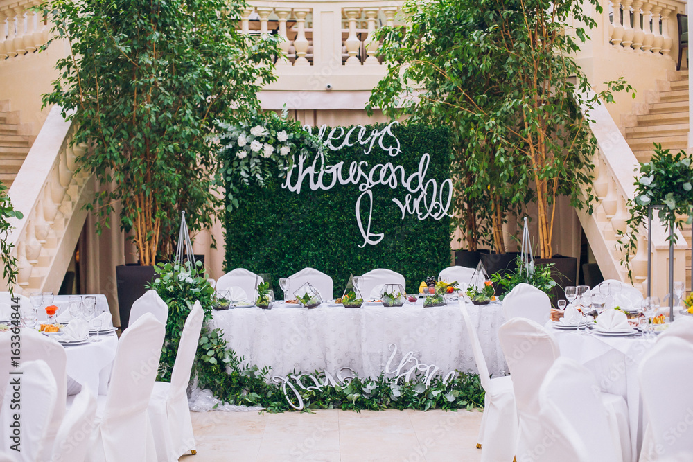 Catering in restaurant. Wedding banquet. Wedding party. Restaurant event. Banquet, wedding, catering, celebration. Wedding restaurant. Served tables. Decor in green and white colors.