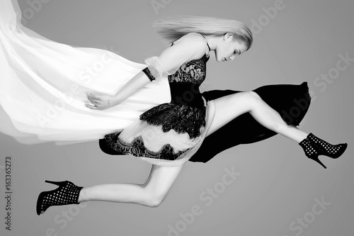 jumping girl in dress and high heels photo