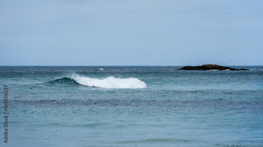 Big surfing ocean sea waves on sandy beach.