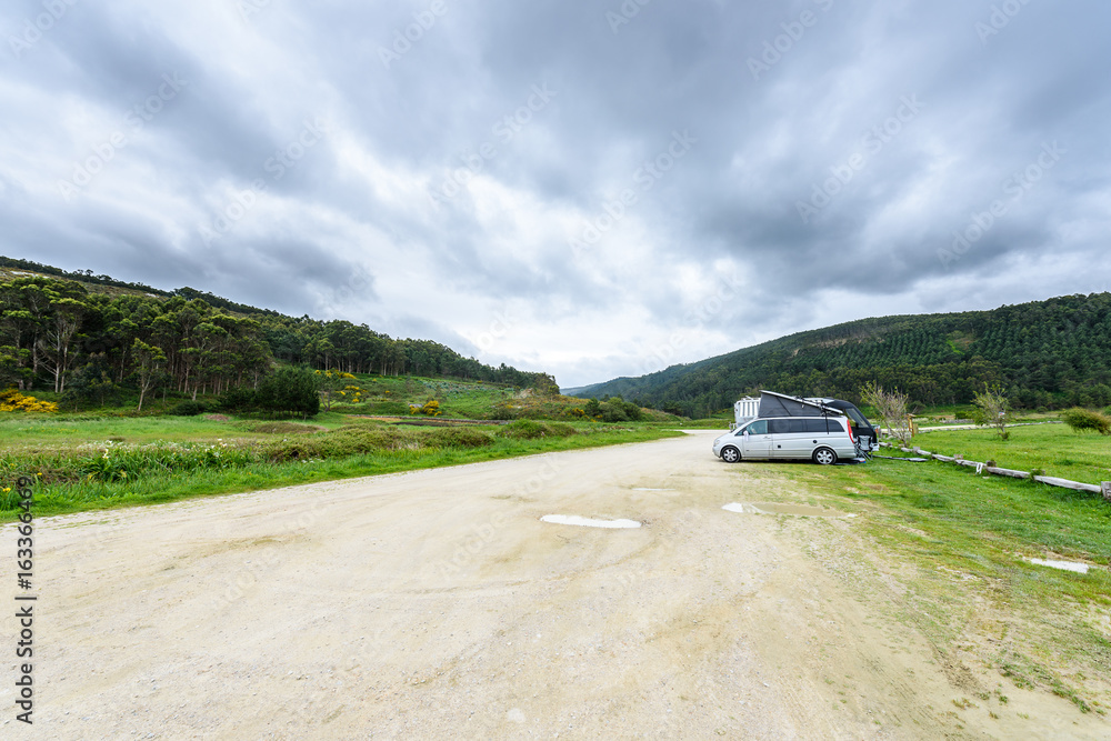 Motorhome RV and campervan are parked on a beach. Motorhome RV and campervan are parked on a beach.