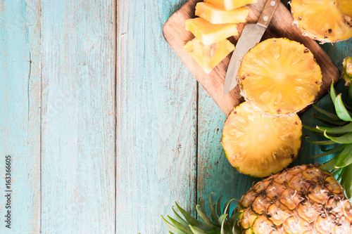 pineapple on the wood texture background..