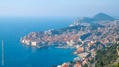 Stunning top view on Dubrovnik in Dalmatia, Croatia. Small bay with fortress towers on the sides. Fort Lovrijenac and stone pier with a lot of boats in the cove. Travel Croatia