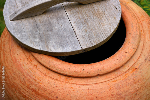 wood lid on big water jar photo