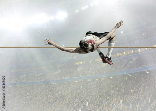 Fototapeta Sportowiec w akcji skoku wzwyż.