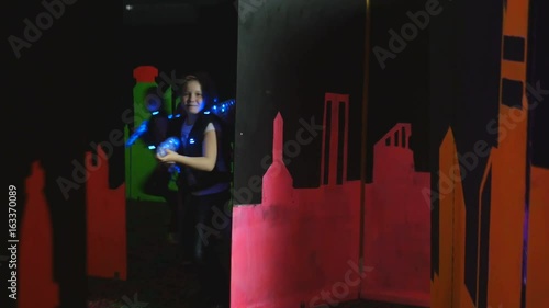 Children playing laser tag in a labyrinth photo