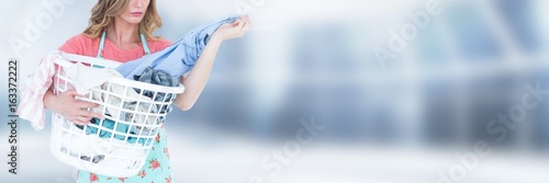 Cleaner holding laundry basket with bright background