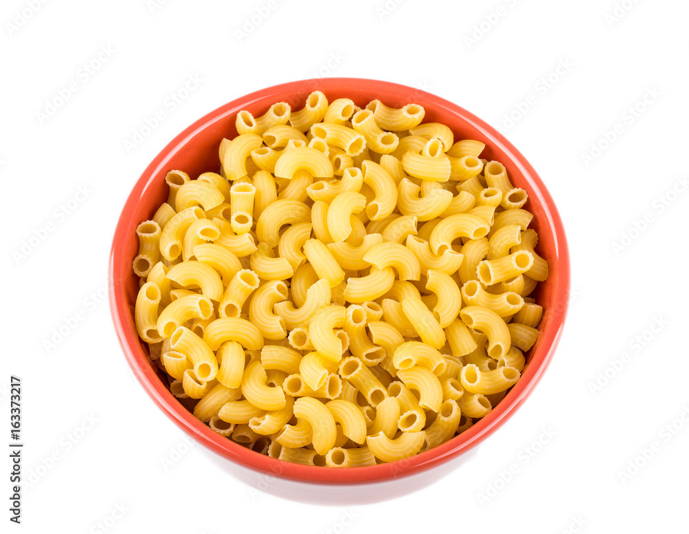 bowl of dried pasta or elbow pasta over white background