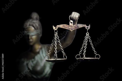 Lady Justice or Themis (God of Justice) isolated on black background photo