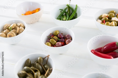 Marinated olives and vegetables on white background