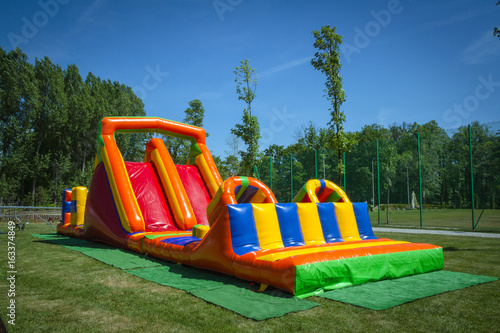 Obraz na płótnie Inflatable big colofrull slide for kids in playground w salonie