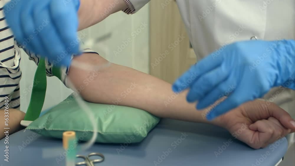 Nurse collecting blood from patient vein Nurse collecting blood from patient vein