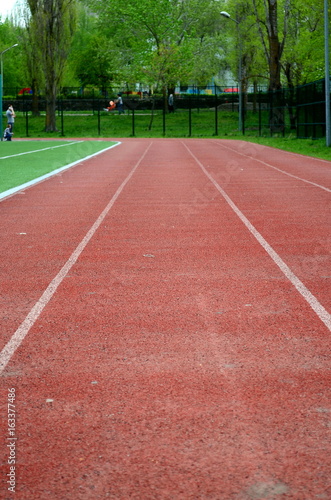 treadmills at the stadium, direct and grass, closeup, background