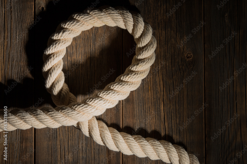 Obraz premium Sea rope on a wooden background.