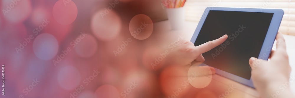 Hand touching tablet with red bokeh transition Hand touching tablet with red bokeh transition