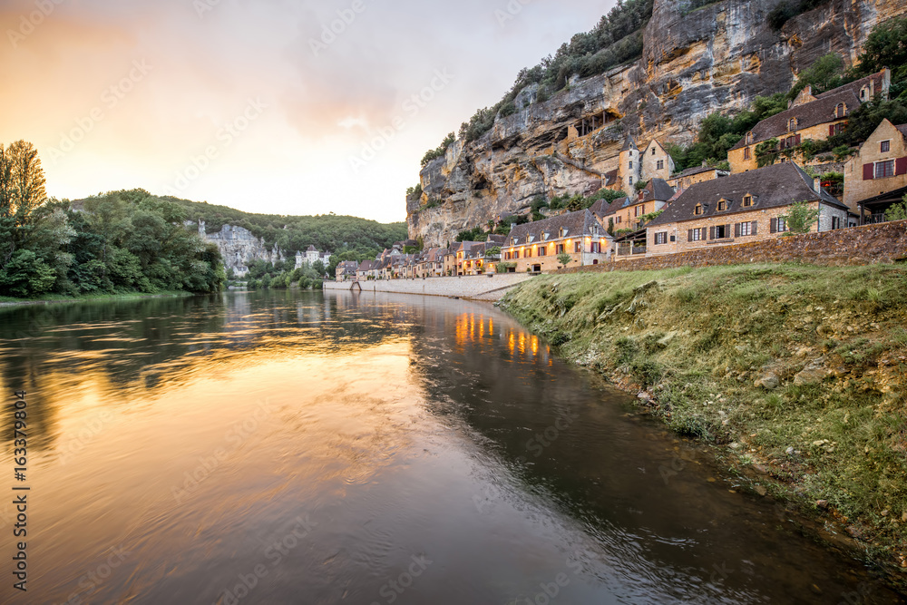 Fototapeta premium Beautiful sunset view on Dordogne river and famous La Roque Gageac village during the rainy weather in France