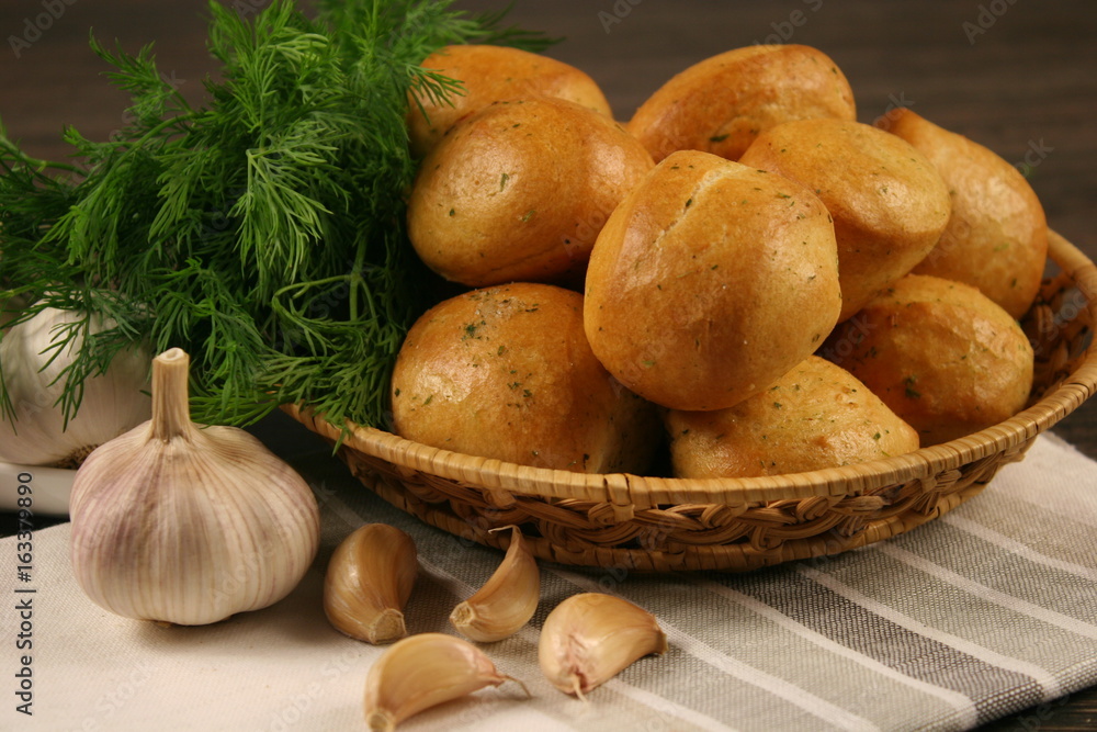 Homemade buns with garlic and dill on wooden table Homemade buns with garlic and dill on wooden table