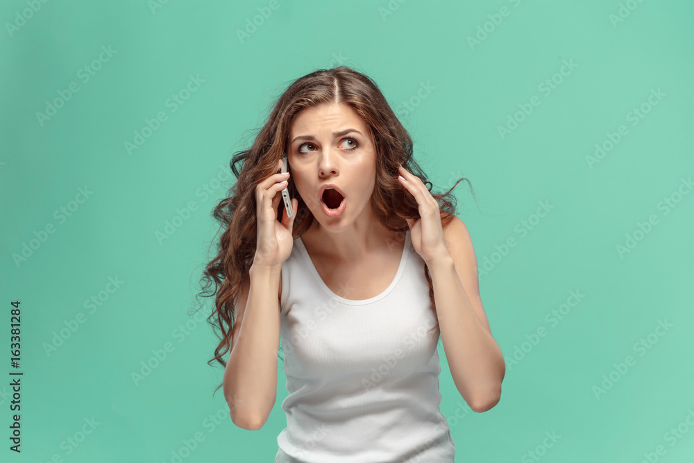 The portrait of disgusted woman with mobile phone The portrait of disgusted woman with mobile phone