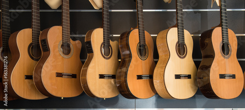 Many Classical Guitars Hanging on Wall in the Shop