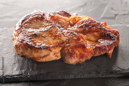 Slika na platnu fried pork steak on a black stone