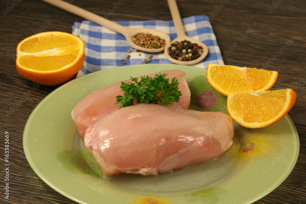 Raw chicken breast and spices close up. Selective focus