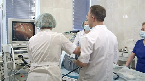Gastroenterologist doctors with probe performing gastroscopy