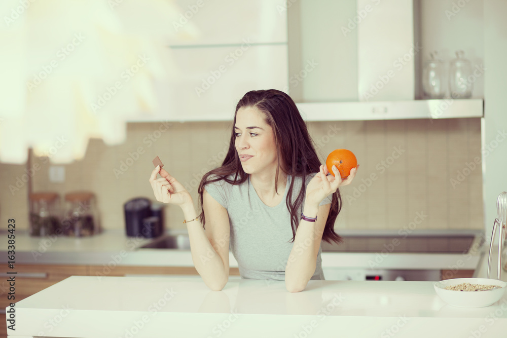 Beautiful young woman breakfast cereals in the kitchen Beautiful young woman breakfast cereals in the kitchen