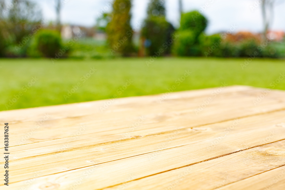 Fototapeta premium Wooden table and green park on background
