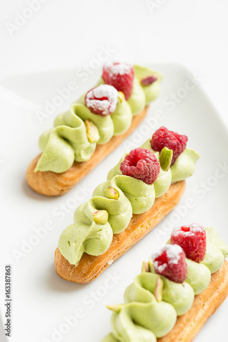 Eclair with pistachio cream and strawberries