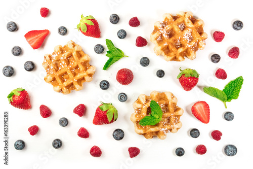 Overhead photo of Belgian waffles with fresh fruit and mint