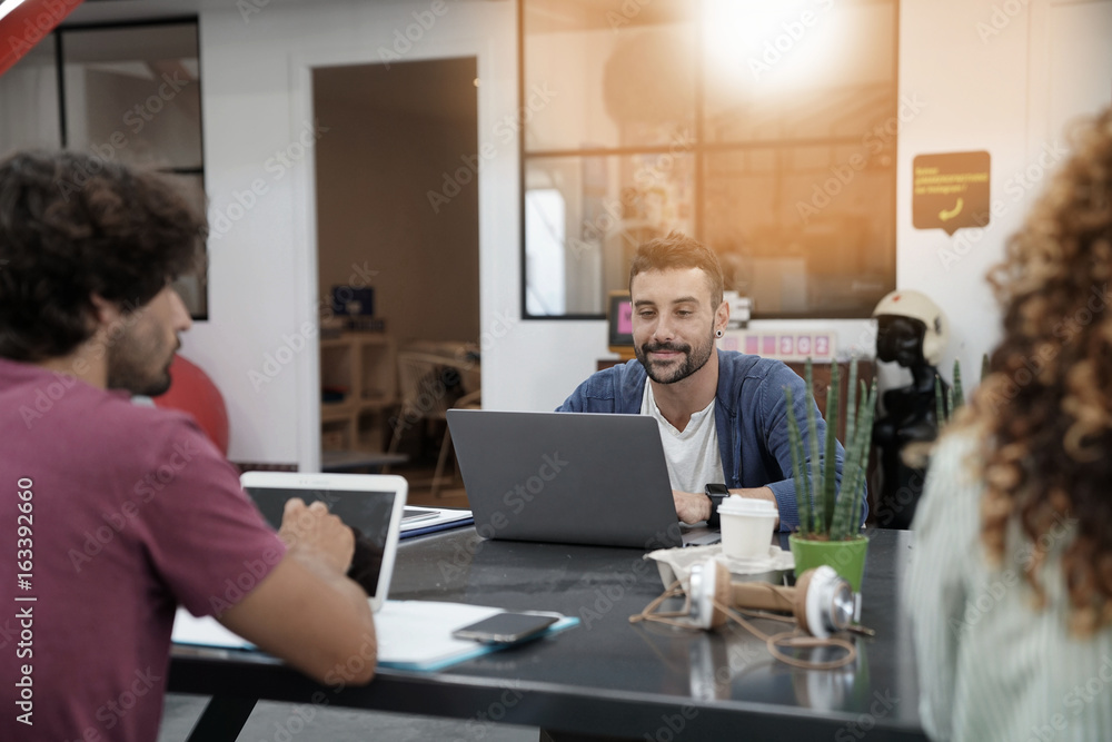 Trendy young people working in co-working office Trendy young people working in co-working office