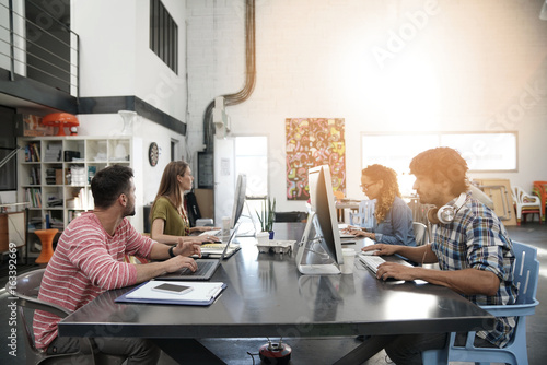 Trendy young people working in co-working office