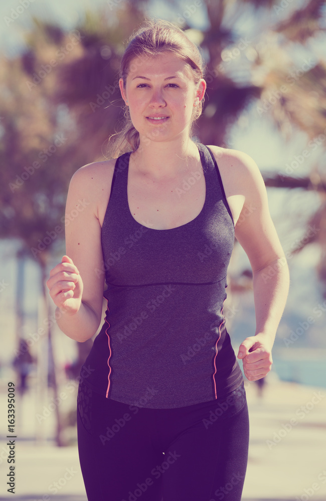 Fototapeta premium Woman jogging during outdoor workout