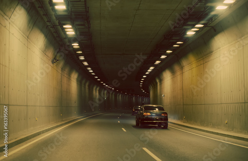 Cars driving through the tunnel.