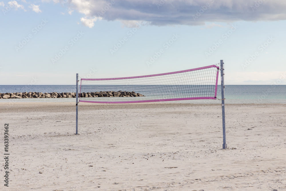 Volleyball net with pink framing on the sea beach south France Volleyball net with pink framing on the sea beach south France