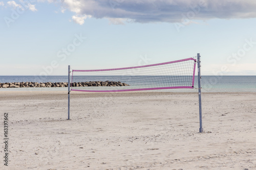 Volleyball net with pink framing on the sea beach south France