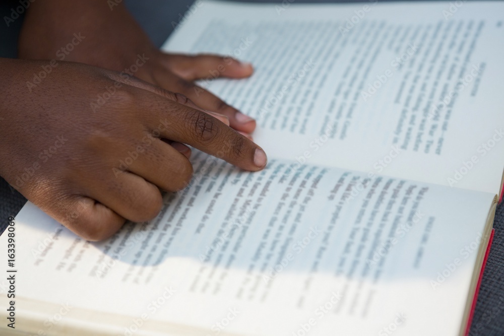 Hands of boy pointing at book Hands of boy pointing at book