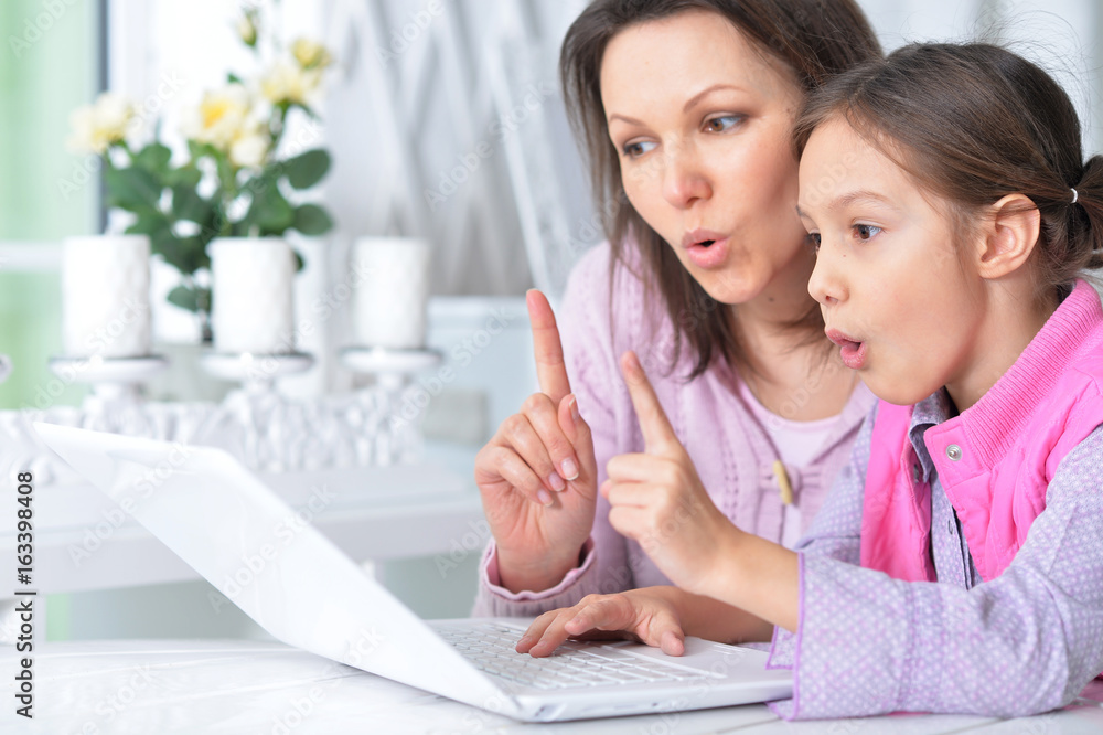 Mother with daughter using laptop Mother with daughter using laptop