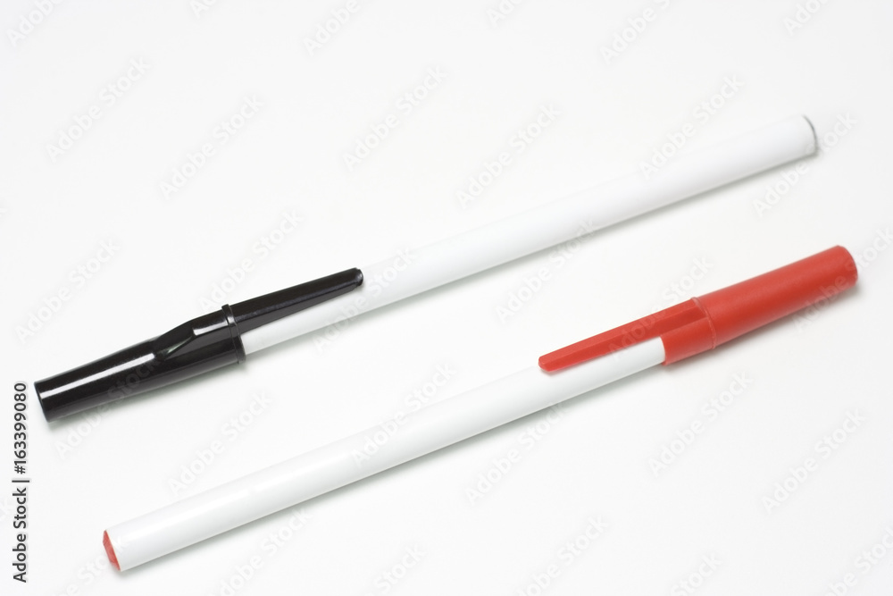 White pens with black and red caps. Isolated. White pens with black and red caps. Isolated.