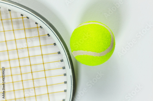 Tennis racket and ball on a white background