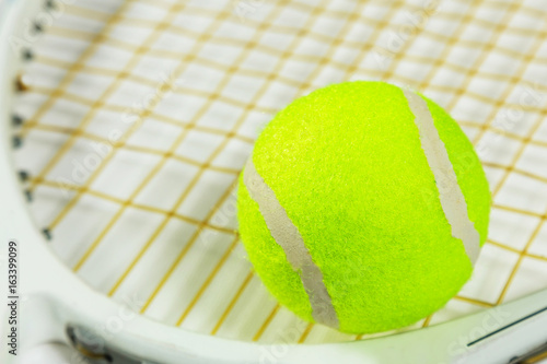 Tennis racket and ball on a white background