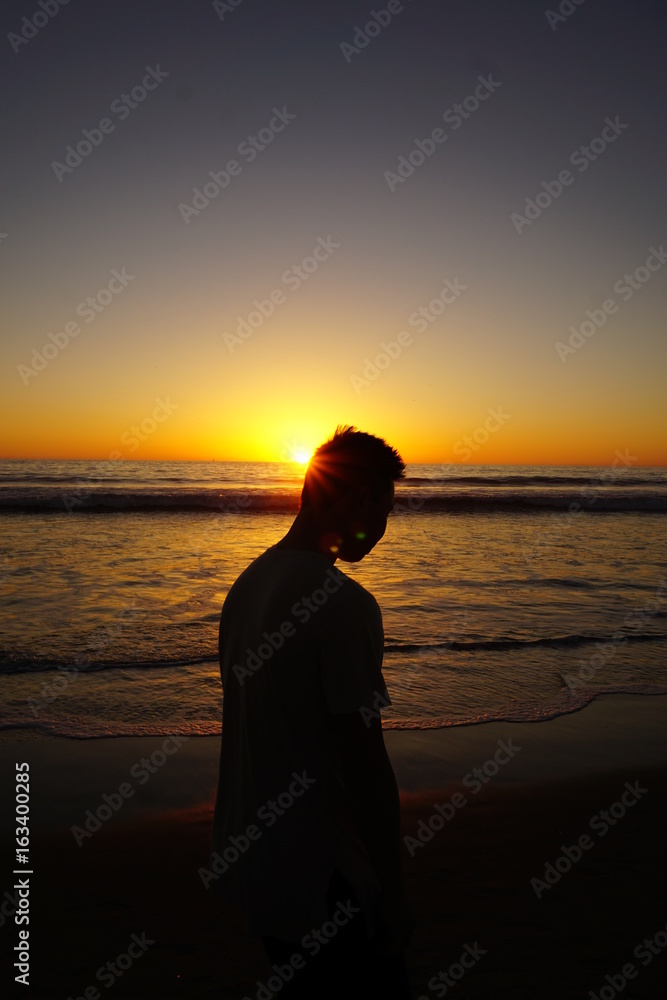 Man deep in thought under sunset 