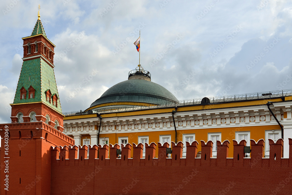 Kremlin wall, tower and Russian flag on Senate building. Moscow, Russia