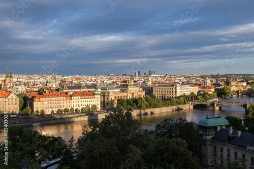Old Town and beyond behind the Vltava River in Prague, Czech Republic, viewed slightly from above in the daytime.