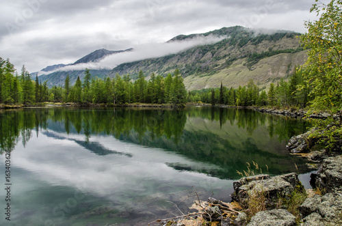 Siberia. Beautiful green fog lake in the forest. Buryatia