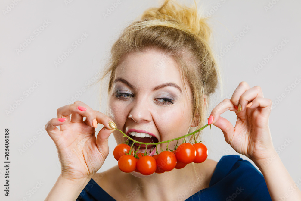 Woman holding fresh cherry tomatoes Woman holding fresh cherry tomatoes