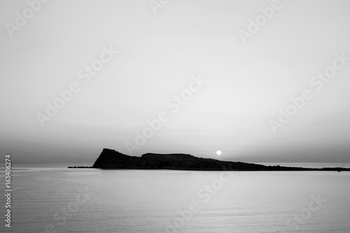Sunrise on the beach, early morning in Kolokitha island, Crete, Greece, black and white photo