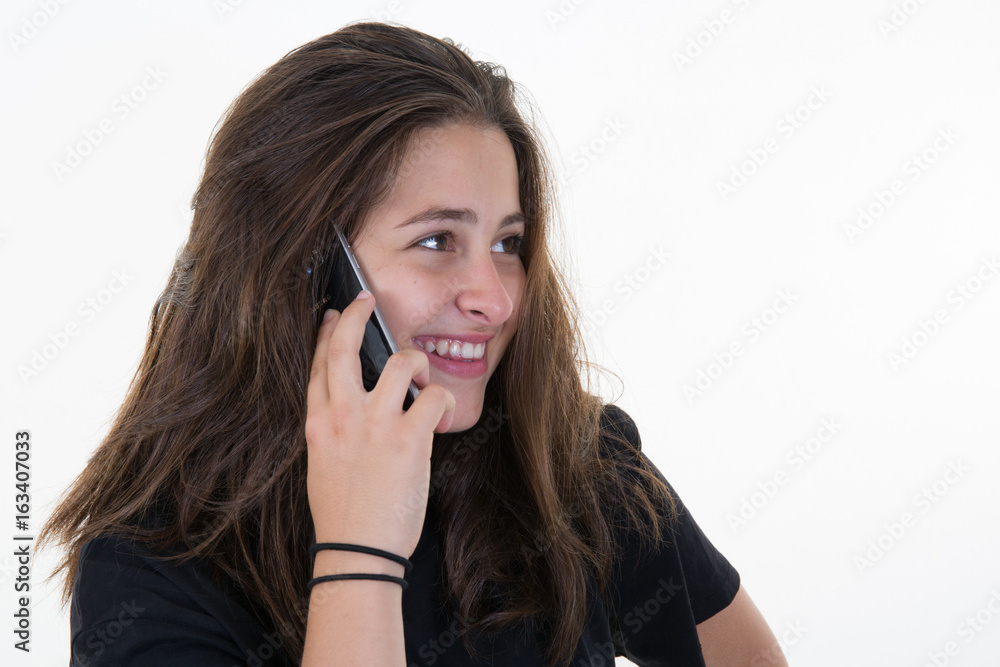 Young beautiful woman at the phone, isolated over a white background Young beautiful woman at the phone, isolated over a white background