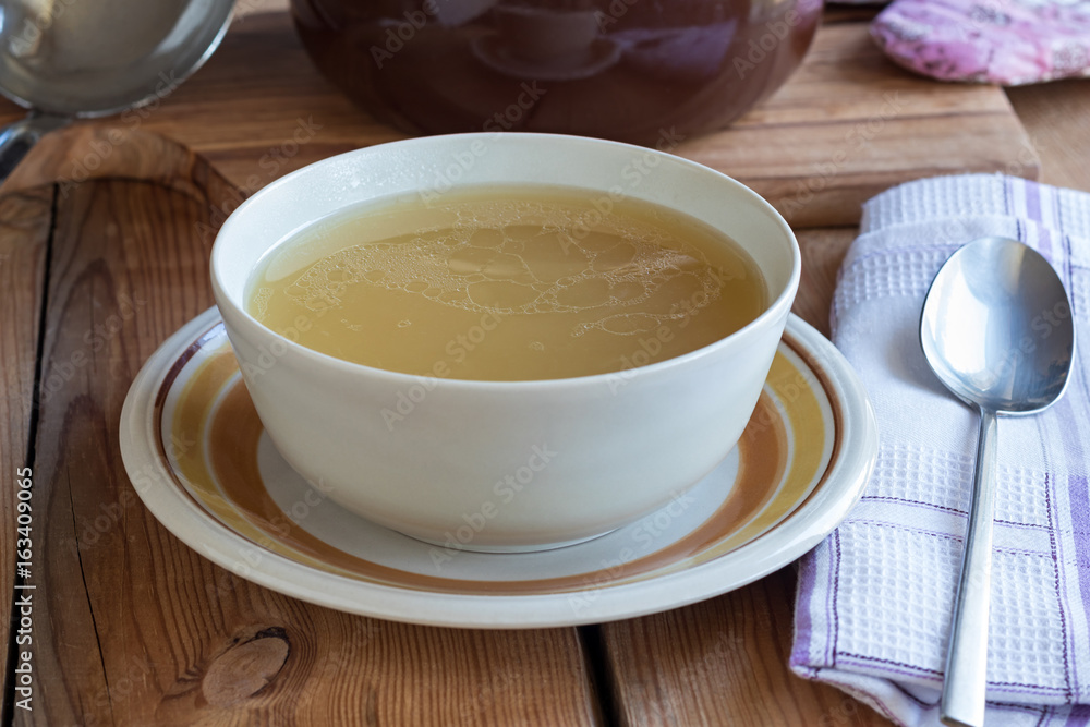 Bone broth made from chicken served in a soup bowl Bone broth made from chicken served in a soup bowl